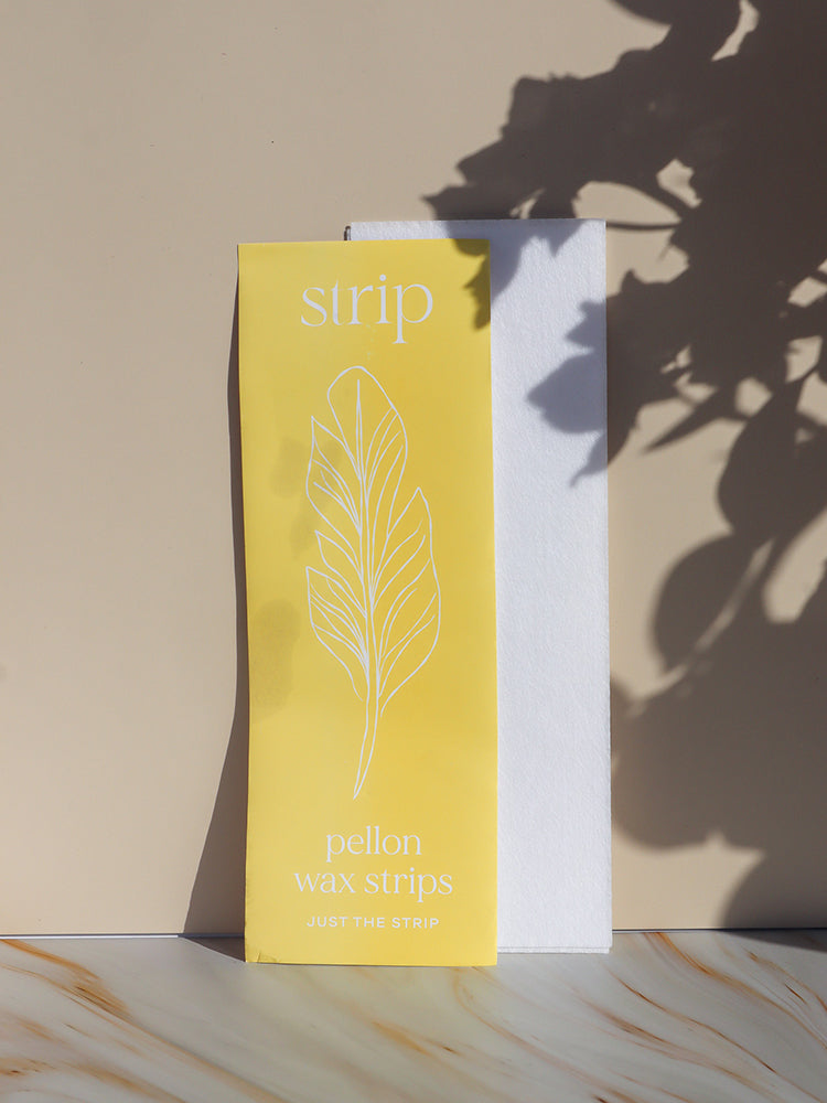 Just The Strip Pellon Waxing Strips 100 pack standing upright with a single white strip behind it